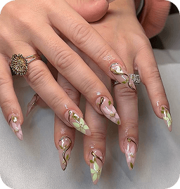 Acrylic nail art with white and green floral designs at J'Adore Nails Cherry Hill